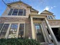 Charming home with a stone and siding exterior, featuring a well-manicured lawn and a welcoming front entrance at 3740 Crowchild Dr, Cumming, GA 30041