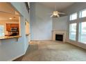 Spacious living room featuring a fireplace, plush carpeting and large windows at 3740 Crowchild Dr, Cumming, GA 30041