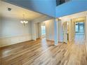 Bright living room with hardwood floors, wainscoting, and views to the entry at 3740 Crowchild Dr, Cumming, GA 30041