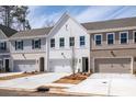 Attractive townhome row featuring diverse architectural styles, inviting garages, and fresh landscaping at 409 Carrera Ln, Acworth, GA 30102