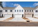 A row of modern townhomes showcases unique facades, integrated garages, and well-maintained front yards at 409 Carrera Ln, Acworth, GA 30102