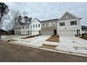 A row of newly constructed townhouses with modern exteriors, two-car garages, and private driveways at 409 Carrera Ln, Acworth, GA 30102