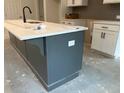 Close-up of a kitchen island with white countertop and gray base cabinets in a new home at 420 Carrera Ln, Acworth, GA 30102