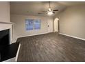 Inviting living area with wood-look flooring, white trim, and a view of the entry door and large window at 4735 Jackam Ridge Ct, Lithonia, GA 30038