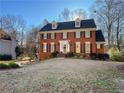 Charming brick two-story home with a manicured lawn and classic American architectural details at 2120 Chartwell Ct, Lawrenceville, GA 30043