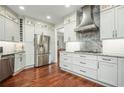 Spacious kitchen features stainless steel appliances, granite countertops and white cabinets at 6435 Ivey Creek Cir, Cumming, GA 30040