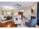 Bright, open-concept living area showcasing hardwood floors, a fireplace, and seamless flow to the dining and kitchen at 950 Brook Knoll Ln, Cumming, GA 30041