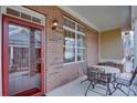 Inviting front porch features a brick facade, a cozy seating area, and a glimpse of the home's entrance at 950 Brook Knoll Ln, Cumming, GA 30041