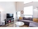 Inviting living room featuring high ceilings, a comfortable sectional sofa, and ample natural light at 1661 La France Ne St # 216, Atlanta, GA 30307