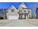 Charming two-story home featuring a combination of brick, stone, and siding, with an attached two-car garage at 3608 Crayton Glen Way, Buford, GA 30519