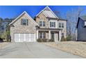 Charming two-story home featuring a combination of brick, stone, and siding, with an attached two-car garage at 3608 Crayton Glen Way, Buford, GA 30519