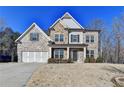 Charming two-story home featuring a combination of brick, stone, and siding, with an attached two-car garage at 3608 Crayton Glen Way, Buford, GA 30519