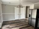 This dining room features laminate flooring, a stainless refrigerator and plenty of space at 304 Deerfield Dr, Jonesboro, GA 30238