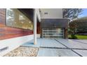 Modern home with unique stone and siding, a glass garage door, and geometric driveway at 1099 Vista Ne Trl, Atlanta, GA 30324