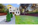 Contemporary two-story home with lush lawn, privacy fence and mature trees at 1099 Vista Ne Trl, Atlanta, GA 30324