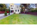 Landscaped front yard with privacy fence, modern two-story design and shade trees at 1099 Vista Ne Trl, Atlanta, GA 30324