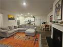 Open-concept living room and kitchen with fireplace, modern decor and comfortable seating at 623 Wayland Ct, Fairburn, GA 30213