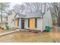 Charming home featuring a gray exterior, black shutters and a well-maintained lawn at 2370 Wingfoot Pl, Decatur, GA 30035