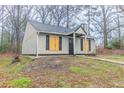 Charming home featuring a gray exterior, black shutters and a well-maintained lawn at 2370 Wingfoot Pl, Decatur, GA 30035