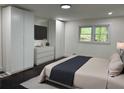 Stylishly decorated bedroom with hardwood floors, built-in storage, and a plush bed at 2899 Tejas Sw Trl, Atlanta, GA 30331