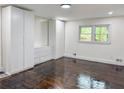 Bright bedroom features hardwood floors, a window, and built-in storage cabinets and drawers at 2899 Tejas Sw Trl, Atlanta, GA 30331