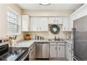 Well-lit kitchen featuring stainless steel appliances, and bright white cabinets at 5024 Bell Se Dr, Smyrna, GA 30080