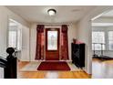 Home's foyer has hardwood flooring, a decorative front door, and a convenient shoe rack at 161 Muddy River Rd, Lawrenceville, GA 30043