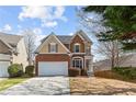 Charming two-story home featuring a brick and siding facade with a well-maintained front yard and attached garage at 4263 Winslow Hill Ct, Suwanee, GA 30024