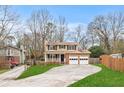 Charming two-story home with brick accents, front porch, long driveway, and attached two car garage at 3775 Norman Rd, Clarkston, GA 30021