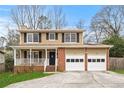 Charming two-story home with brick accents, front porch, and attached two car garage at 3775 Norman Rd, Clarkston, GA 30021