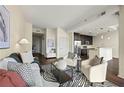 Open-concept living room with kitchen access, contemporary decor, and plenty of natural light at 1080 Peachtree Ne St # 2207, Atlanta, GA 30309