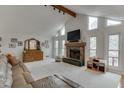 Bright living room featuring a stone fireplace, vaulted ceiling, and large windows at 3852 Old Bridge Way, Duluth, GA 30096