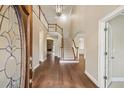 Elegant foyer with hardwood floors, staircase, and chandelier at 6445 Glen Oaks Ln, Sandy Springs, GA 30328