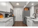 Updated kitchen featuring white cabinets, stainless steel appliances, and marble countertops at 100 Biscayne Nw Dr # E1, Atlanta, GA 30309