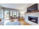 Bright living room featuring hardwood floors, a fireplace, and lots of natural light at 2336 Vistamont Dr, Decatur, GA 30033