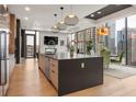 Modern kitchen with large center island, stainless steel appliances, and city views at 40 12Th Ne St # 1503, Atlanta, GA 30309