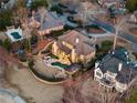 Stunning aerial view of a large home featuring a pool, fire pit, playground, and landscaped backyard at 6955 Laurel Oak Dr, Suwanee, GA 30024