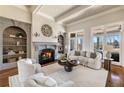 Cozy living room with a fireplace, built-in bookshelves, and large windows for natural light at 6955 Laurel Oak Dr, Suwanee, GA 30024