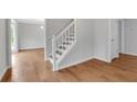 Bright entryway with hardwood floors and white trim staircase at 1429 Christiana Dr, Lawrenceville, GA 30043