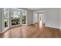 Bright living room featuring hardwood floors, bay window and freshly painted neutral walls at 1429 Christiana Dr, Lawrenceville, GA 30043