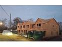 Newly framed townhomes showing windows and rooflines during the final phases of construction at 11606 E Lovejoy Rd, Hampton, GA 30228