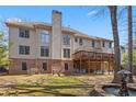 Back of home featuring a deck, patio, and a fountain in the landscaped backyard at 1270 Seale Dr, Alpharetta, GA 30022