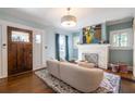 Bright living room features hardwood floors, fireplace, and a dark wood front door at 902 E Ponce De Leon Ave, Decatur, GA 30030