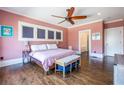 Serene bedroom with hardwood floors and a view into the main bathroom at 902 E Ponce De Leon Ave, Decatur, GA 30030