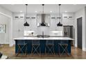 Modern kitchen with white cabinets, stainless steel appliances, and a large island with seating for four at 660 Timm Valley Ne Rd, Atlanta, GA 30305