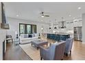 Open-concept living room with hardwood floors, fireplace, and connection to the kitchen at 660 Timm Valley Ne Rd, Atlanta, GA 30305