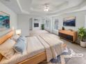 Spacious main bedroom with tray ceilings, a fireplace, and natural light from many windows at 5132 Silhouette Sw Ln, Mableton, GA 30126