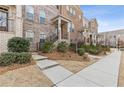 Well-maintained townhome with brick exterior, inviting entry, and neat landscaping at 3374 Grey St, Duluth, GA 30096