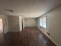 Spacious living room with wood floors, large window, and abundant natural light at 5080 Springtree Ct, Lithonia, GA 30038