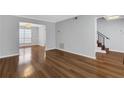 Spacious room featuring gorgeous wood floors and neutral paint at 11 Newport Nw Pl, Atlanta, GA 30318